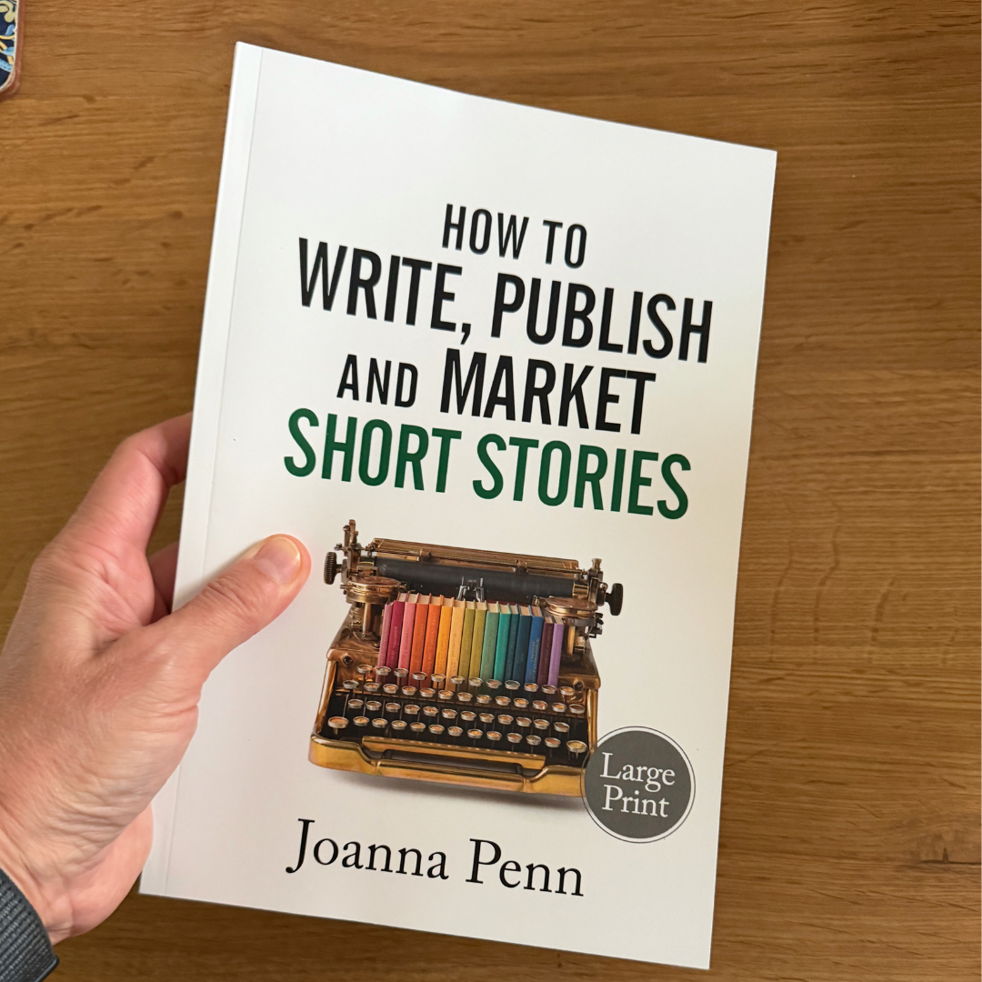 Hand holding the How to Write, Publish, and Market Short Stories Large Print edition by Joanna Penn