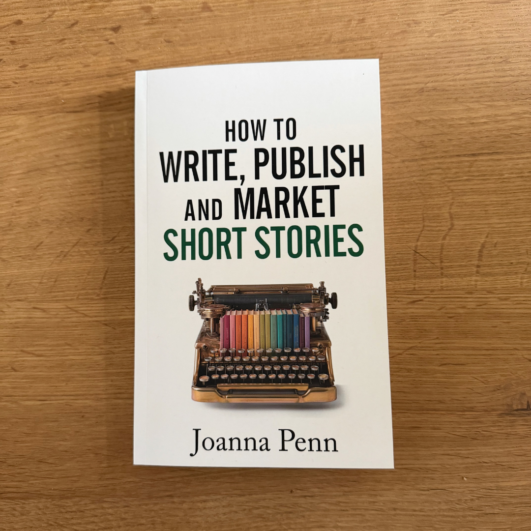 How to Write, Publish, and Market Short Stories paperback by Joanna Penn on a wooden desk