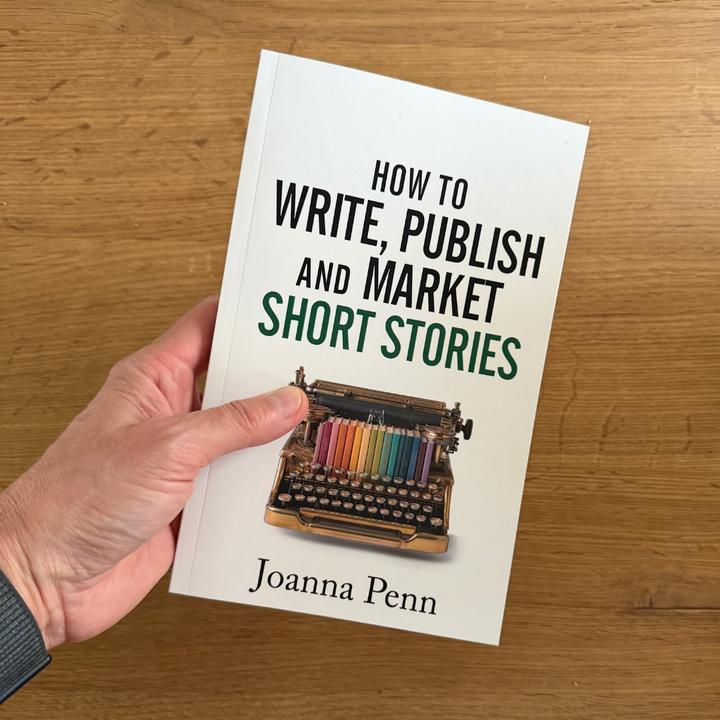 Hand holding the How to Write, Publish, and Market Short Stories paperback by Joanna Penn